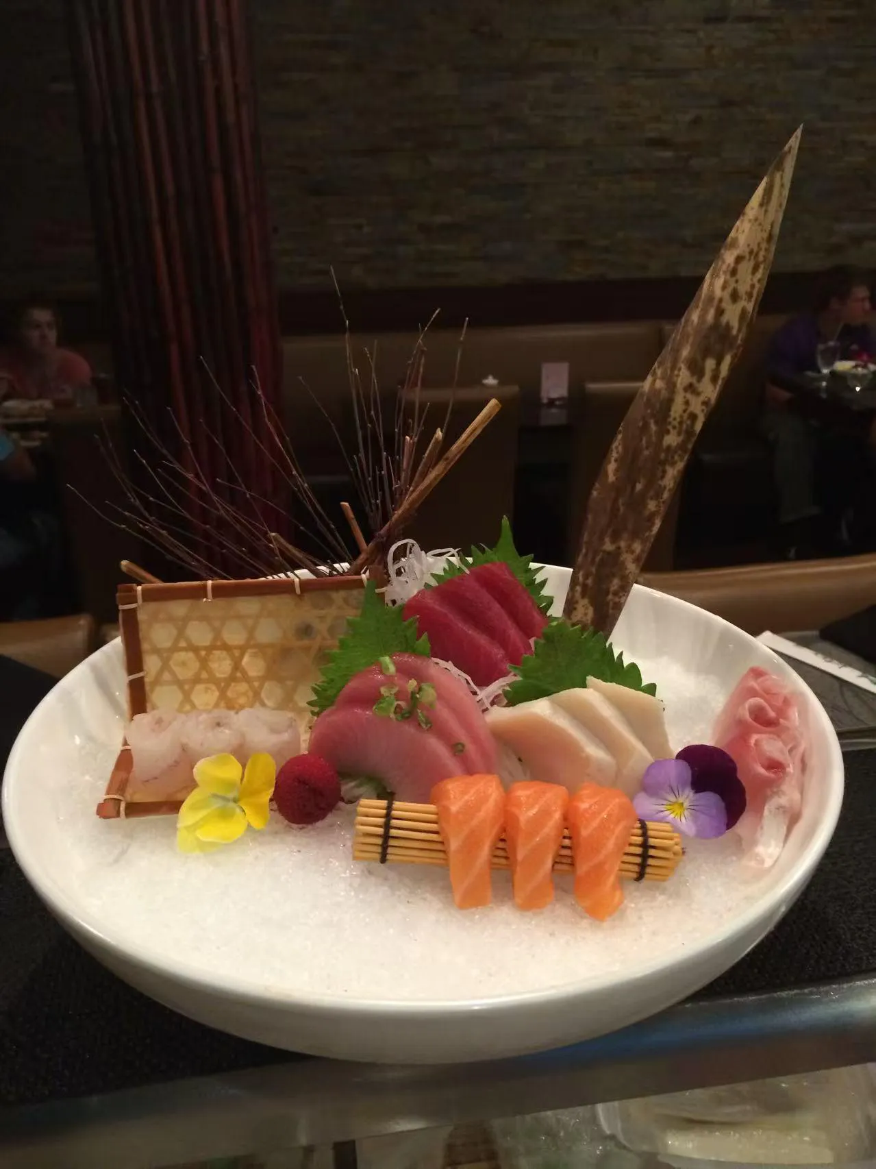 Sashimi platter with edible flower garnish at Kumo Japanese Cuisine Restaurant in Depew
