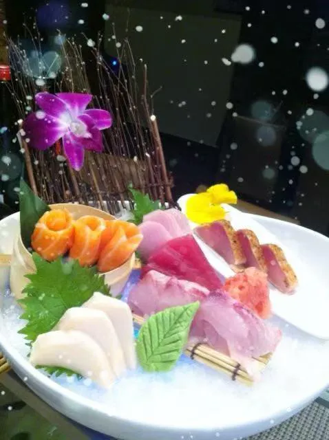 Sashimi assortment with decorative orchid at Kumo Japanese Cuisine Restaurant in Depew