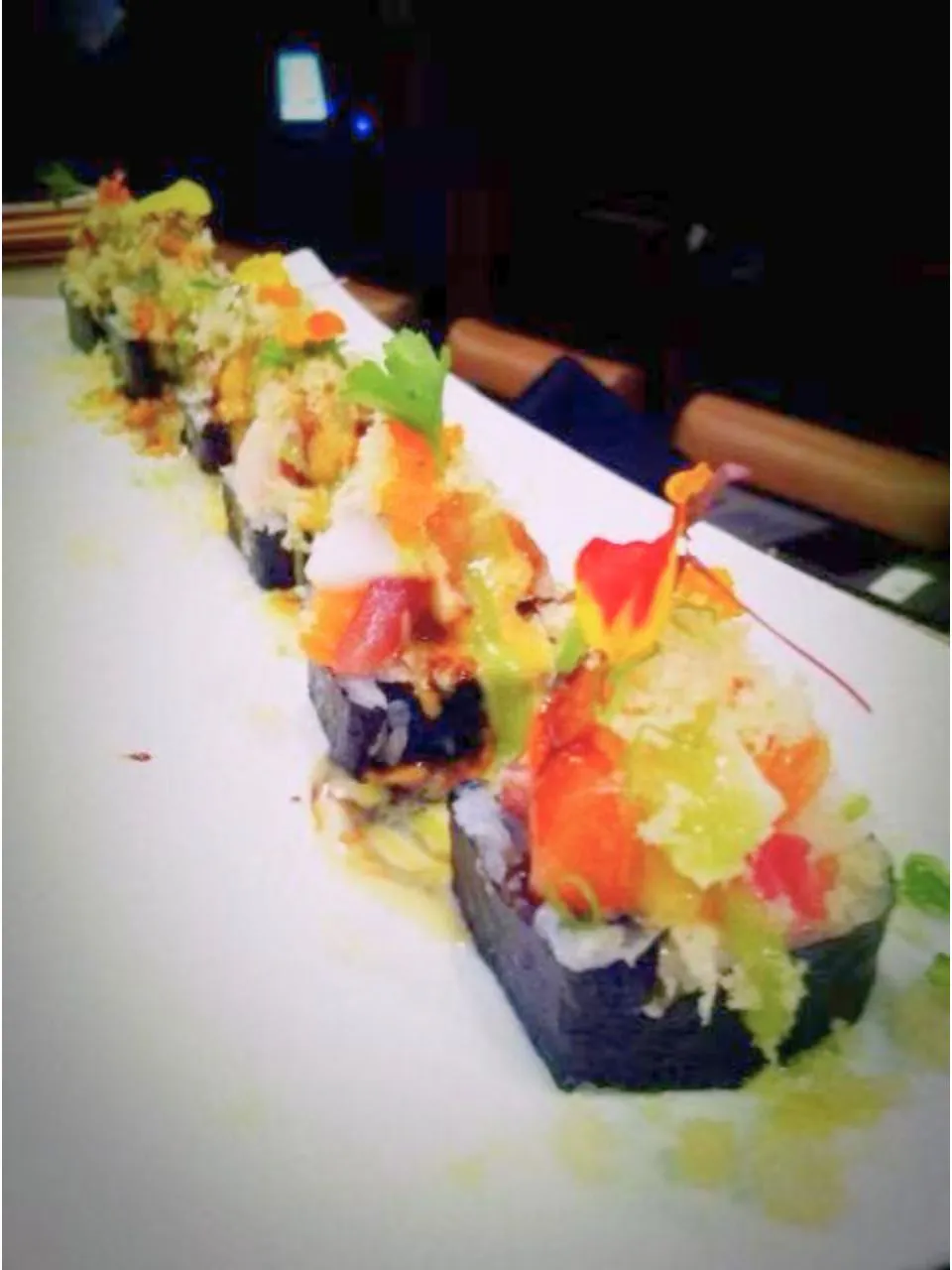 Garnished specialty sushi roll with sauces at Kumo Japanese Cuisine Restaurant in Depew